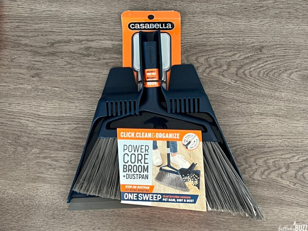 The Casabella Click Clean and Organize Power Core Brom and Dustpan still in its packaging on a grey background