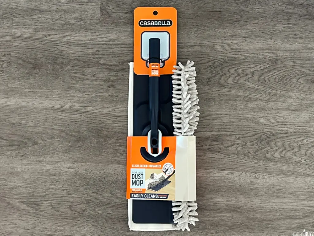 The Right Angle Dust Mop still in its packaging on a grey background