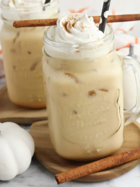 Finished Copycat Starbucks pumpkin Cold Cream Brew in a mason jar topped with whipped cream and a sprinkle of pumpkin pie spice.