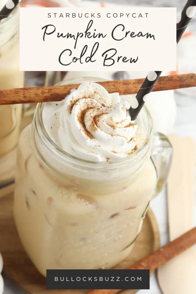 Close up of two glasses of Copycat Starbucks Pumpkin Cream Cold Brew topped with whipped cream and a sprinkle of pumpkin pie spice, with black and whit straws.