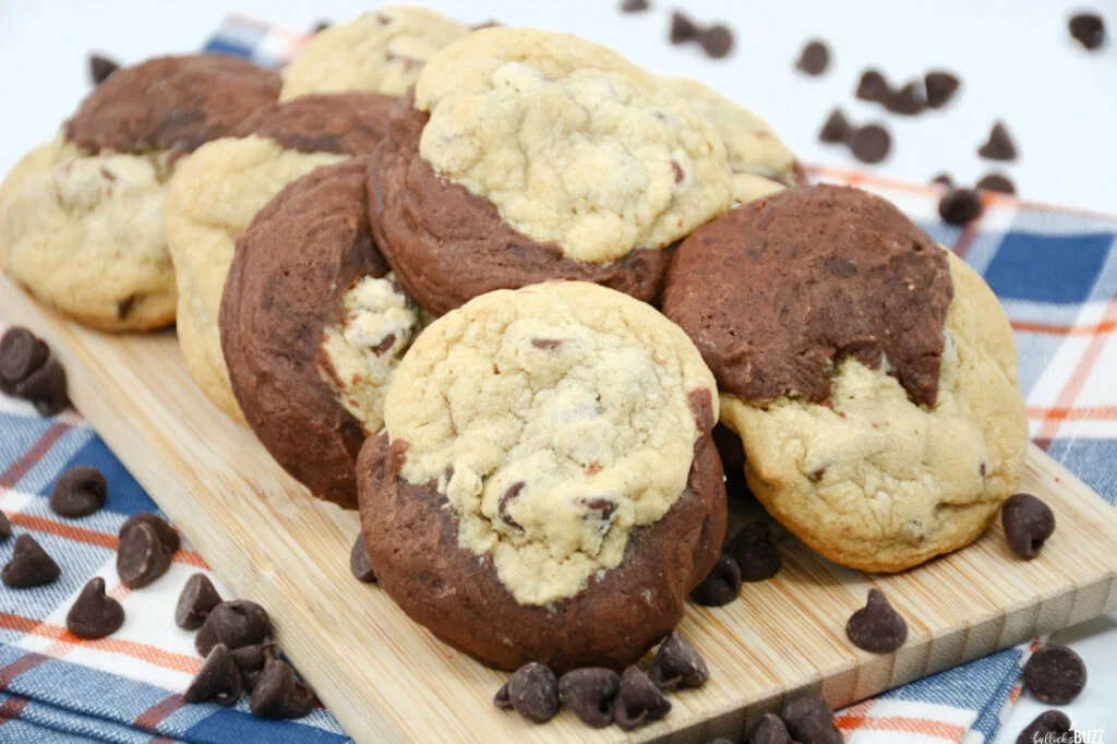 Rows of brookie cookies laid out on a board on top of blue and white fabric