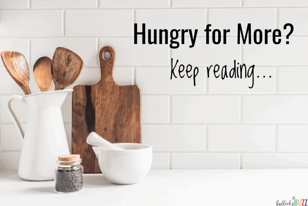Image of a kitchen counter with wood cutting board, wood tools, a white mortar and pestle, and a small jar of peppercorns