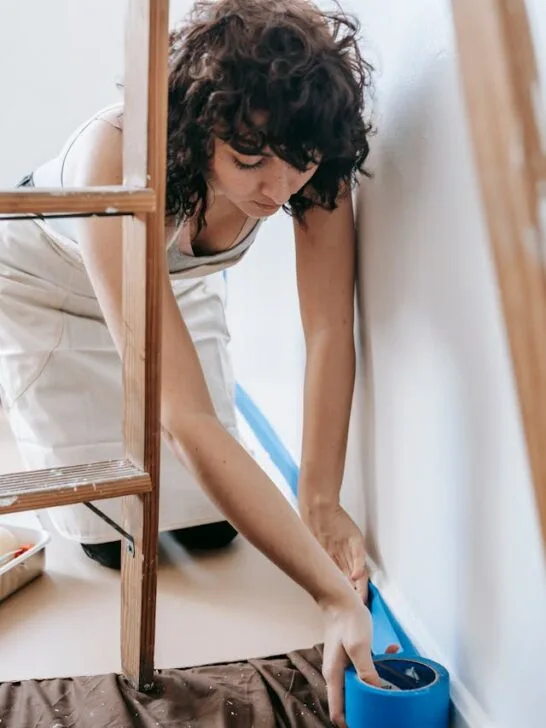 a woman getting ready to paint as one of the easy DIY touch-ups that help your home sell fast