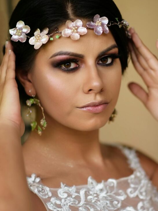 Bride with glowing skin on your wedding day wearing floral headpiece and lace gown, showing a radiant bridal look.