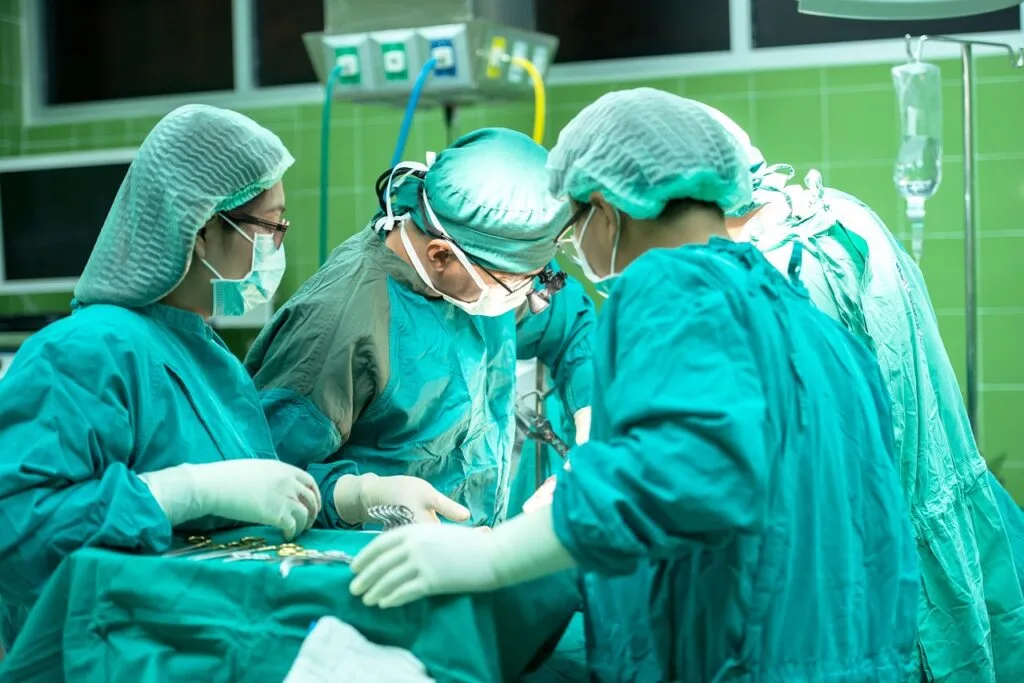 Medical team performing surgery in an operating room, representing why people choose plastic surgery for health and appearance.