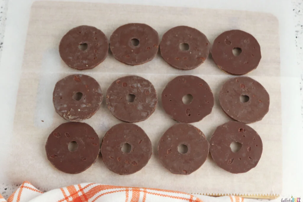Fudge Stripe cookies placed upside down on parchment paper for Pilgrim hat cookies