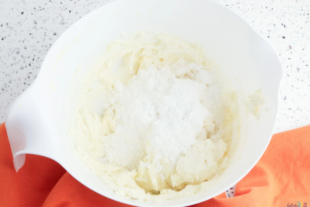 Cream cheese frosting ingredients in a bowl before mixing.