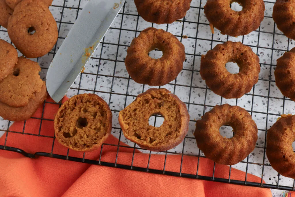 Trimming the bottoms then cooling the cakes on a wire rack before frosting
