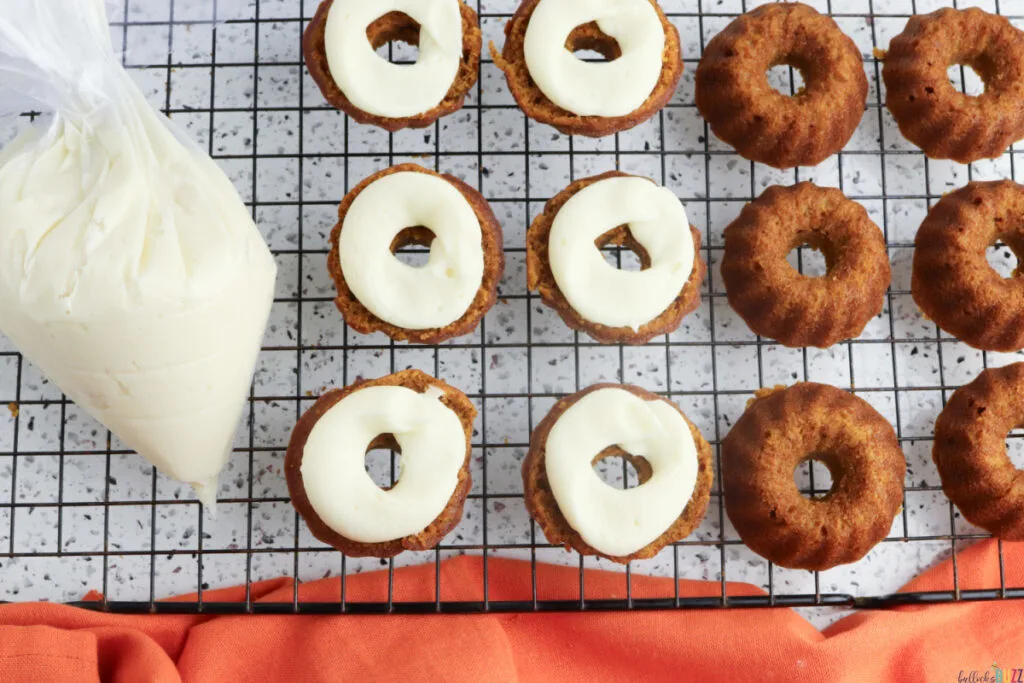 Frosting spread on one half of mini Bundt cake before stacking