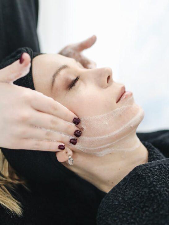 A woman enjoying a relaxing facial treatment at a spa, showcasing the benefits of skin wellness and self-care.