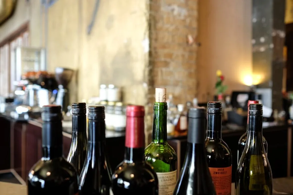 An inviting lineup of assorted wine bottles inside a rustic tasting room, showcasing local Tennessee wines ready for sampling.
