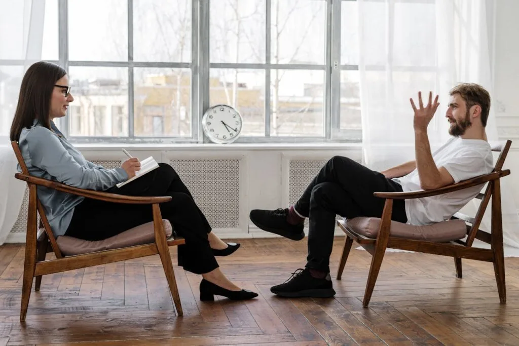 Therapist and client talking during a counseling session, illustrating effective mental health therapy techniques for emotional support.