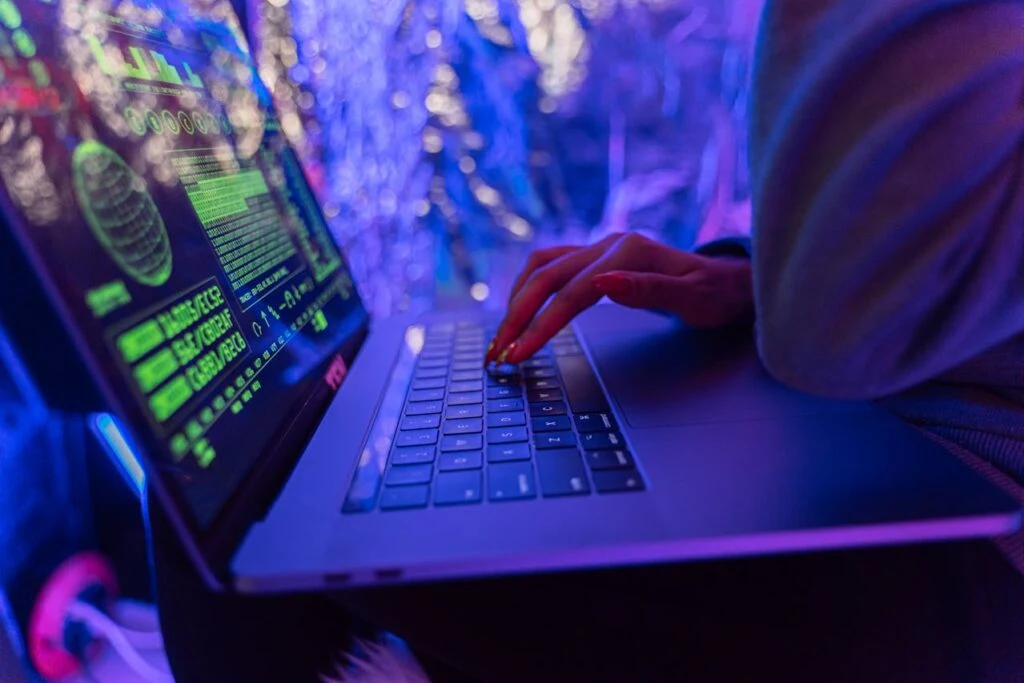 Person typing on a laptop with digital security visuals illustrating a post-quantum encryption strategy in modern systems.