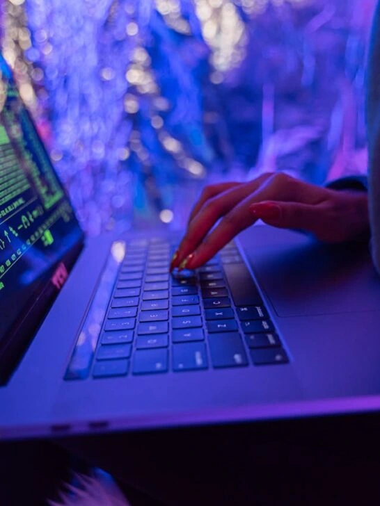 Person typing on a laptop with digital security visuals illustrating a post-quantum encryption strategy in modern systems.