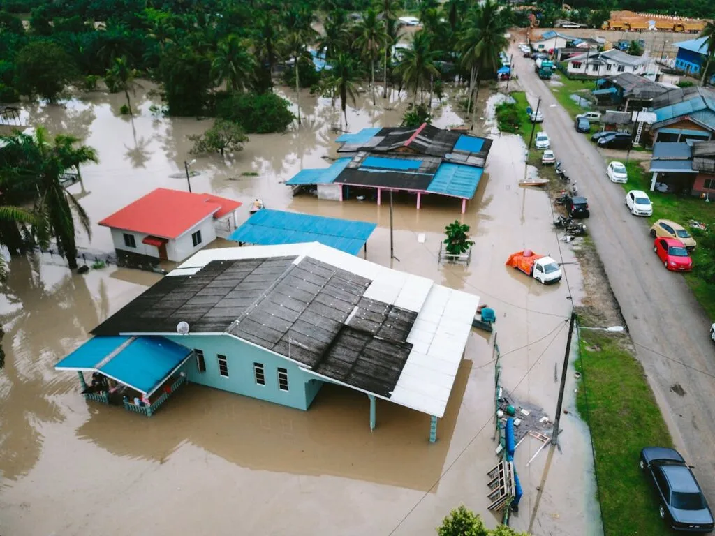 Storm damage inspection showing flooded homes and streets after severe weather, highlighting widespread property and water damage