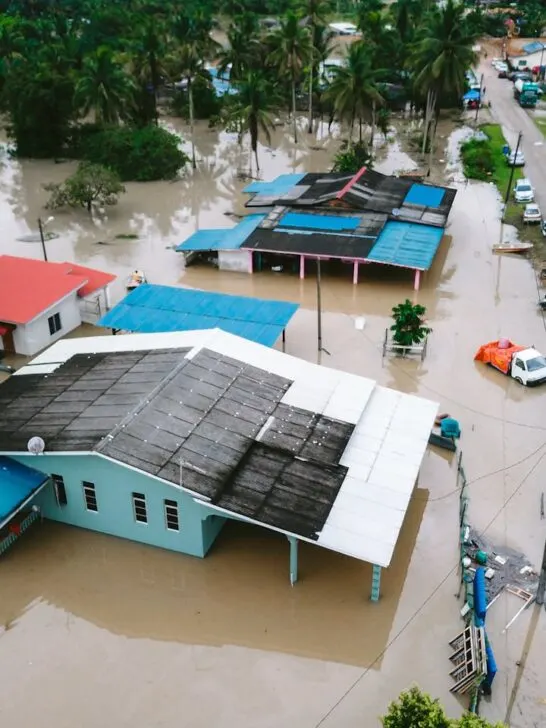 Storm damage inspection showing flooded homes and streets after severe weather, highlighting widespread property and water damage