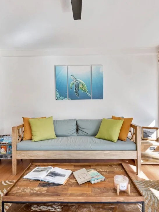 Bright, airy living room filled with natural light and greenery showing the connection between home design and mental health.