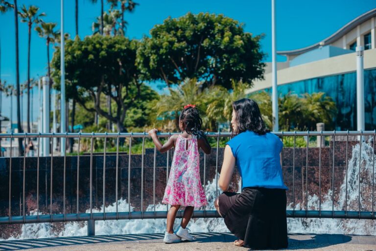 A foster carer spending quiet one-on-one time with a child outdoors, showing trust, reassurance, and everyday connection.