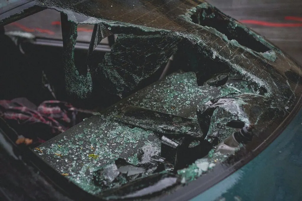 Shattered car windshield and broken glass inside a vehicle, showing damage after a crash and highlighting what to do after a car accident.