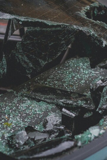 Shattered car windshield and broken glass inside a vehicle, showing damage after a crash and highlighting what to do after a car accident.