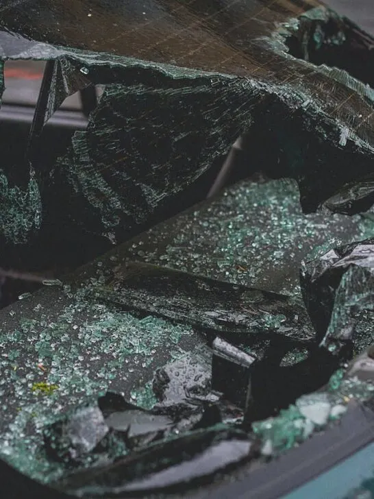 Shattered car windshield and broken glass inside a vehicle, showing damage after a crash and highlighting what to do after a car accident.