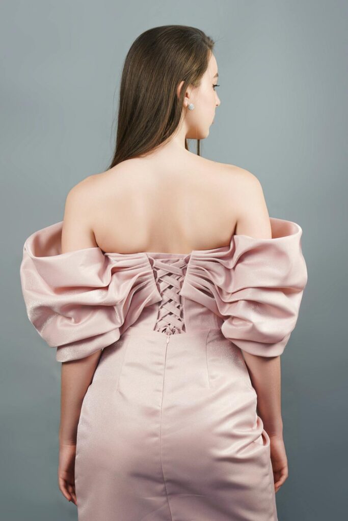 luxury fashion dress with structured off-shoulder design and corset back detail showcasing craftsmanship and elegance