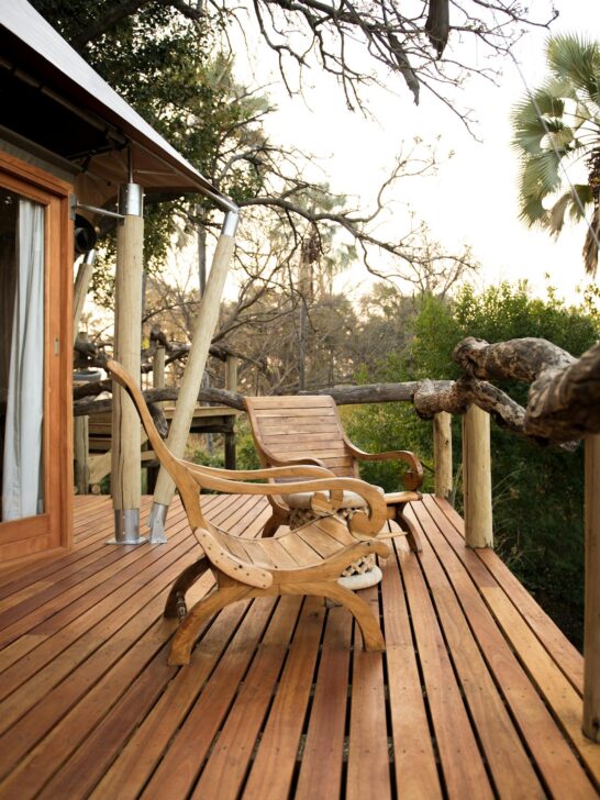 deck design ideas featuring wooden outdoor seating on a modern backyard deck with natural surroundings