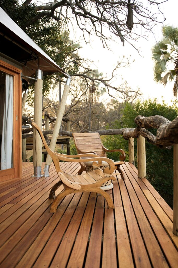 deck design ideas featuring wooden outdoor seating on a modern backyard deck with natural surroundings