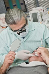 Dentist performing a procedure while focusing on dental health and aesthetic appeal during a patient exam