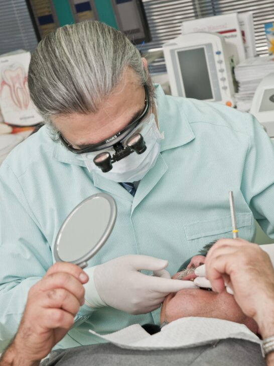 Dentist performing a procedure while focusing on dental health and aesthetic appeal during a patient exam