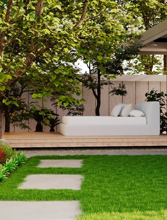 modern backyard with green lawn, shade trees, garden beds, and cozy outdoor seating area