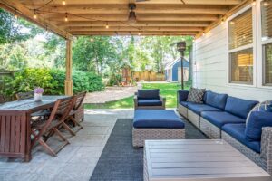family-friendly backyard design with covered patio seating, outdoor dining area, and kids play space in backyard