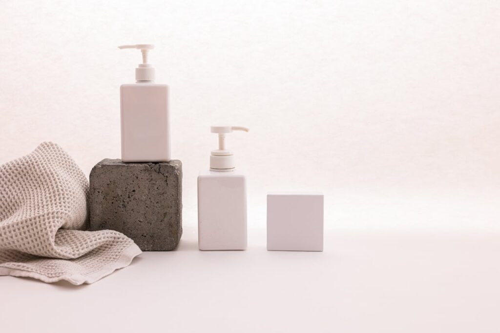 Minimalist wellness products display with lotion bottles, soap, and neutral spa-style setup