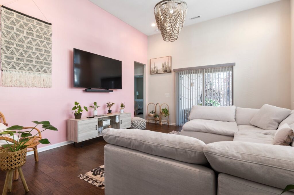 how to make your living room feel warm and inviting with soft neutral seating, plants, and cozy lighting accents