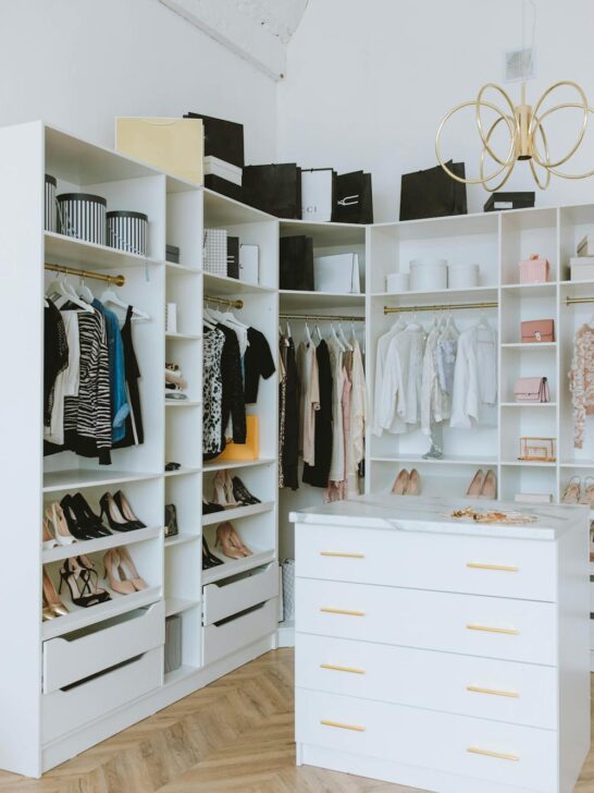 Organized white closet with shoes and clothing, showing how to refresh your wardrobe on a budget with smart styling and organization