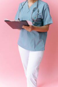 role of nurse practitioners in healthcare shown by medical professional in scrubs holding a clipboard with stethoscope