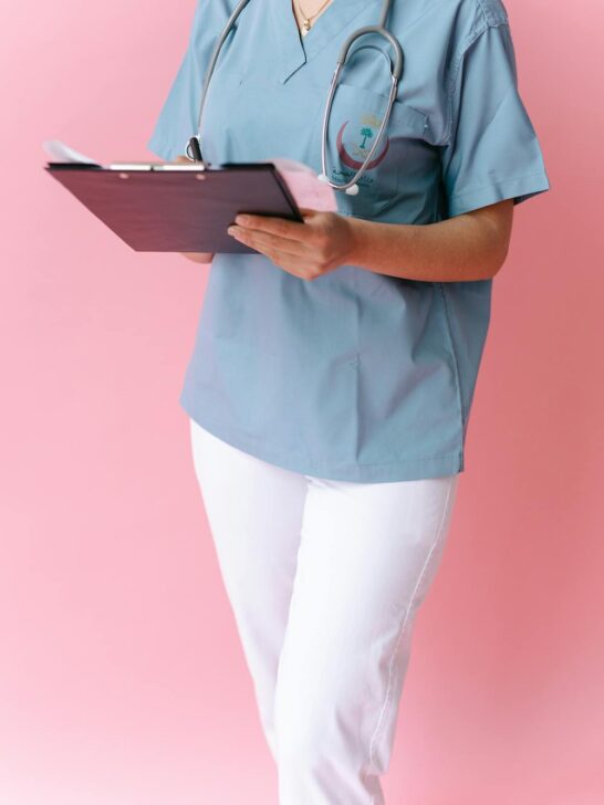 role of nurse practitioners in healthcare shown by medical professional in scrubs holding a clipboard with stethoscope