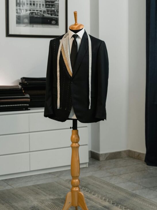 Tailored black suit jacket displayed on a mannequin showing craftsmanship and structure for what to look for when buying a custom suit.