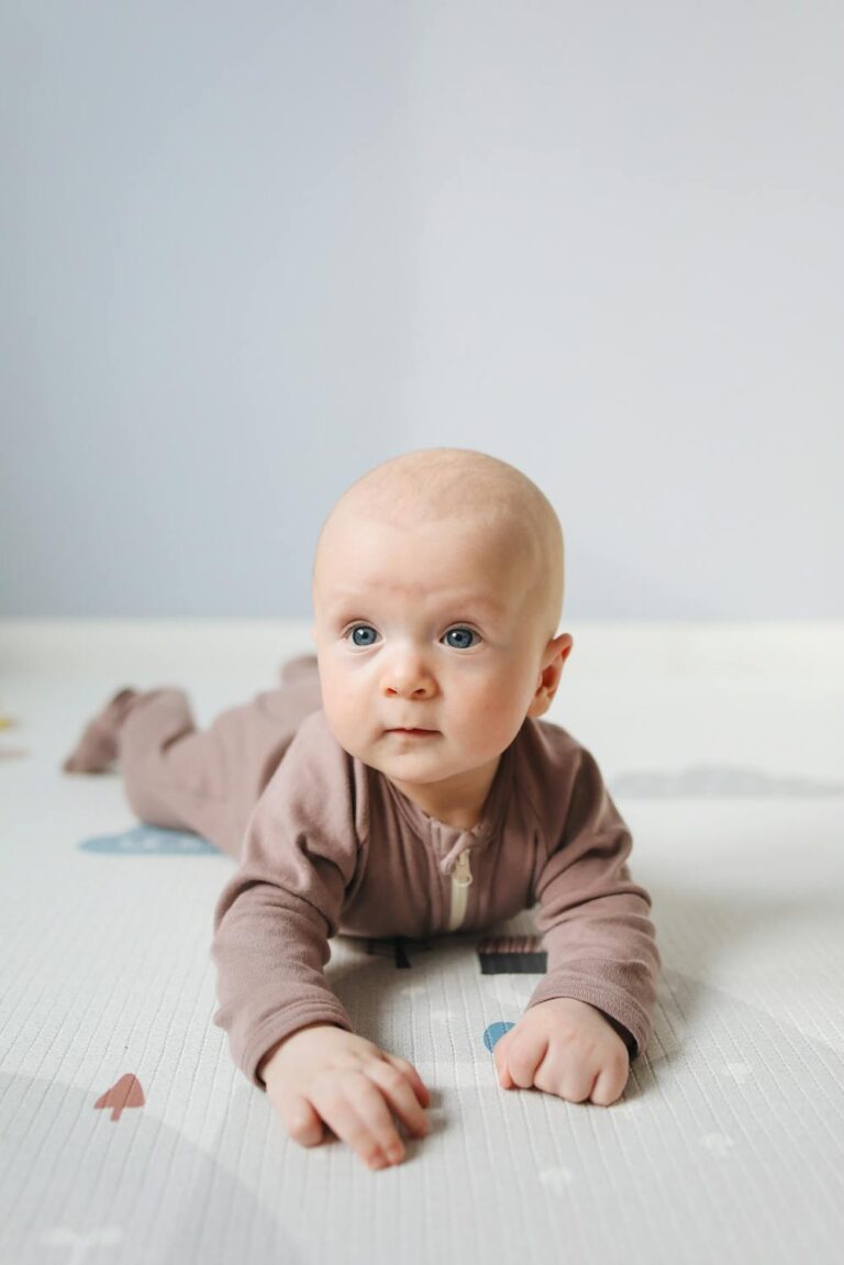 Baby lying on tummy during playtime, representing gentle care with natural baby products