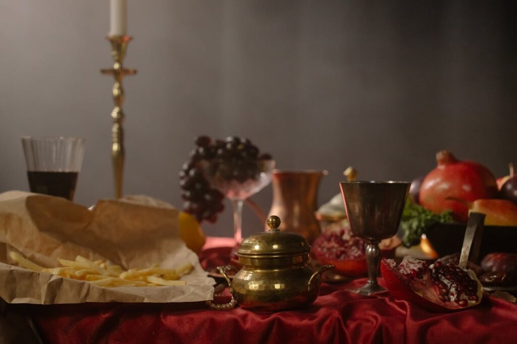 Rustic Renaissance feast table with goblets, bread, fruit, and candlelight creating a medieval party atmosphere
