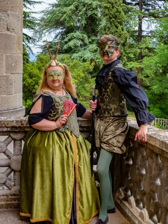 Renaissance party ideas with guests wearing medieval costumes and masks at a themed outdoor gathering