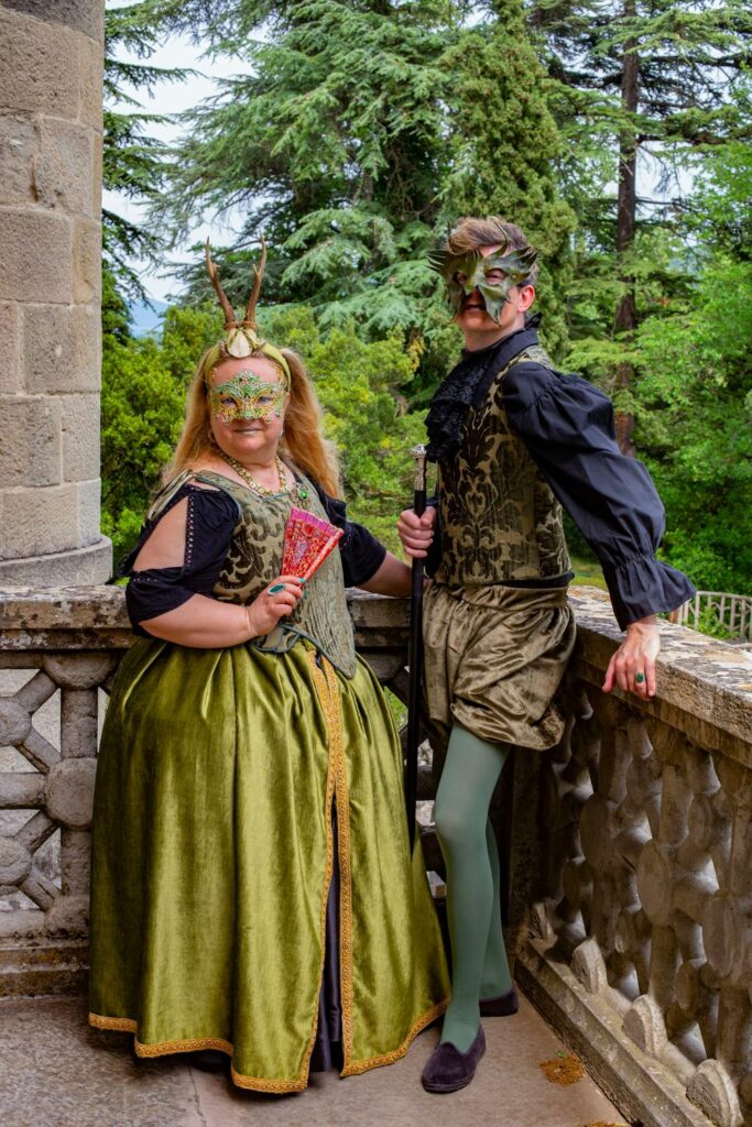 Renaissance party ideas with guests wearing medieval costumes and masks at a themed outdoor gathering