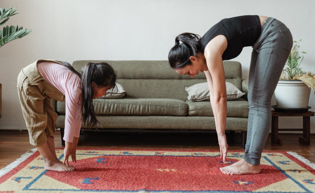 best family-friendly exercises at home with parent and child stretching together on living room rug
