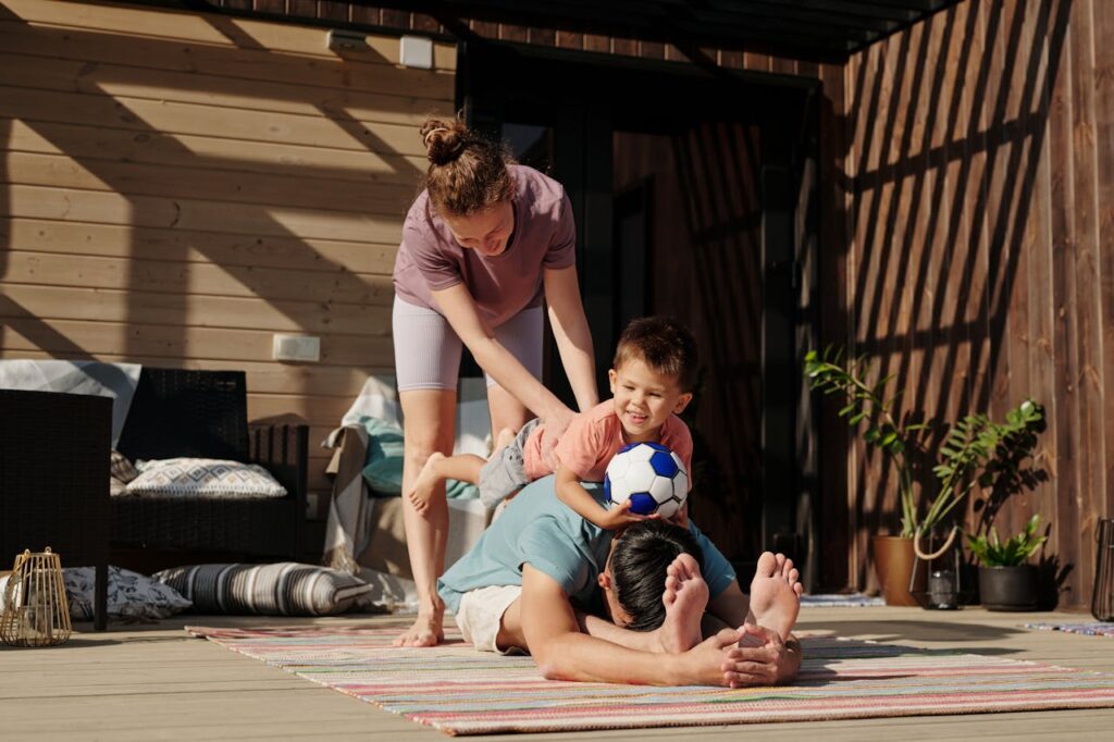family exercising together outdoors  on their home patio