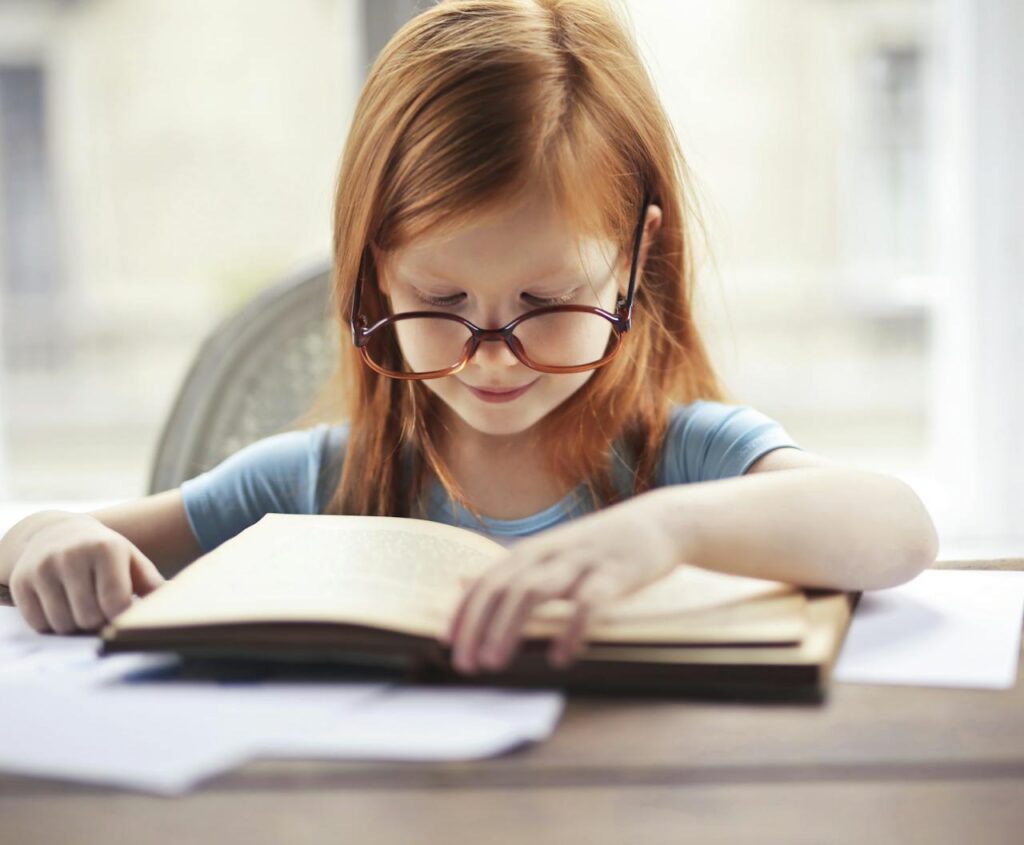 child reading book close-up