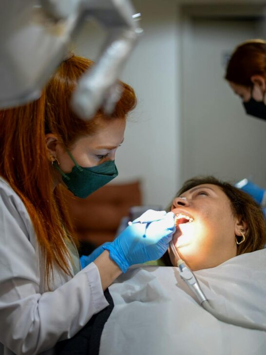 Dentist performing emergency dental repair on a patient using modern dental tools in a clinic setting
