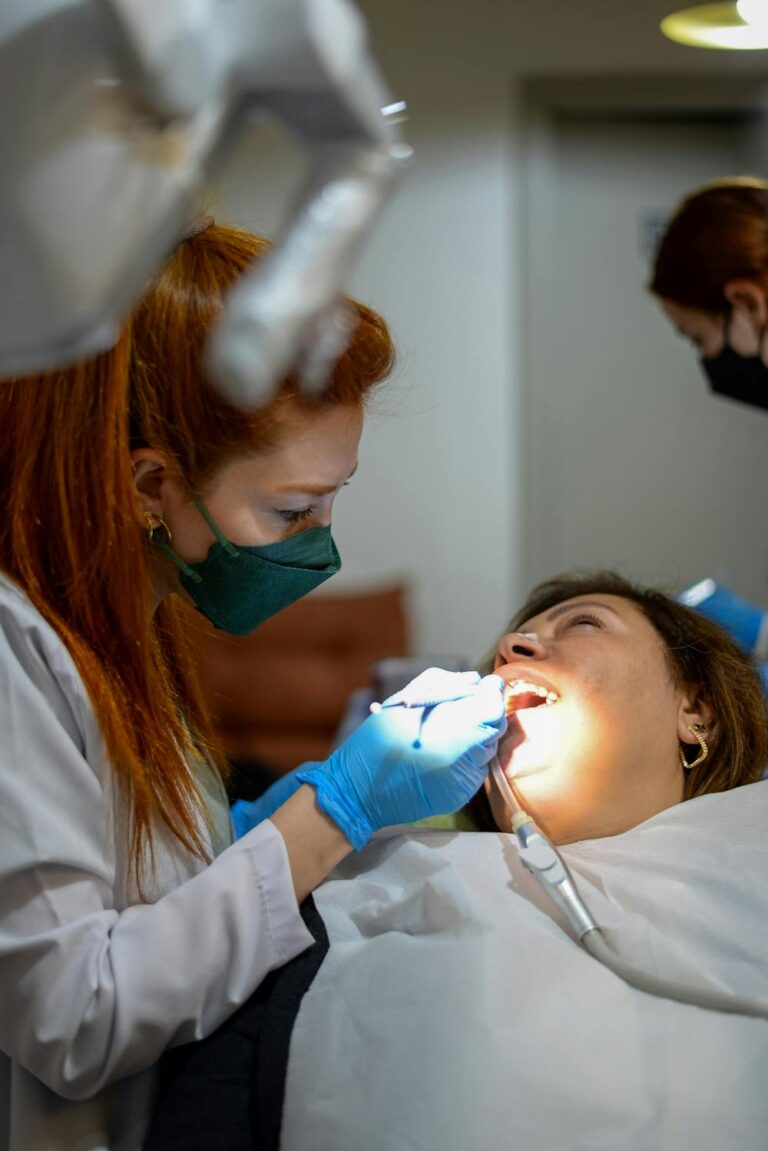 Dentist performing emergency dental repair on a patient using modern dental tools in a clinic setting