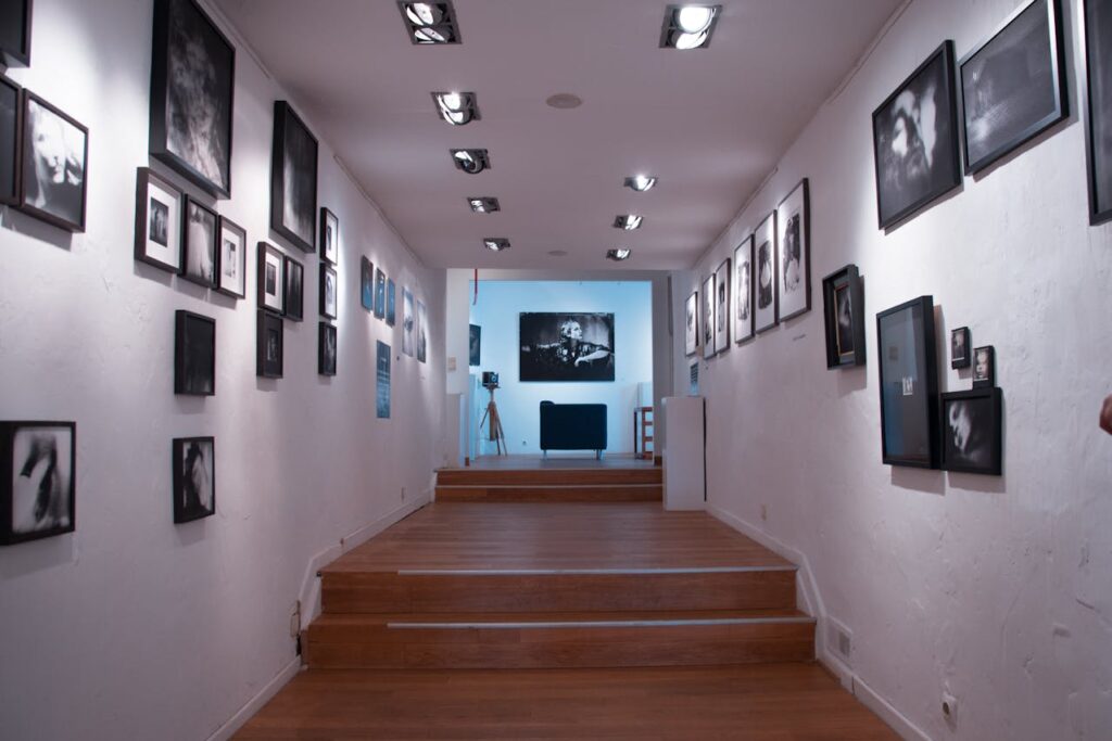 Hallway gallery wall with evenly spaced black-and-white framed photos along both sides