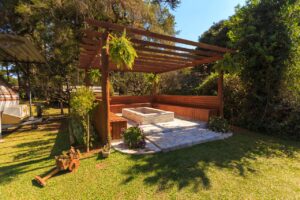 Backyard pergola with partial shade creating a cooler seating area when a backyard is too hot to sit outside