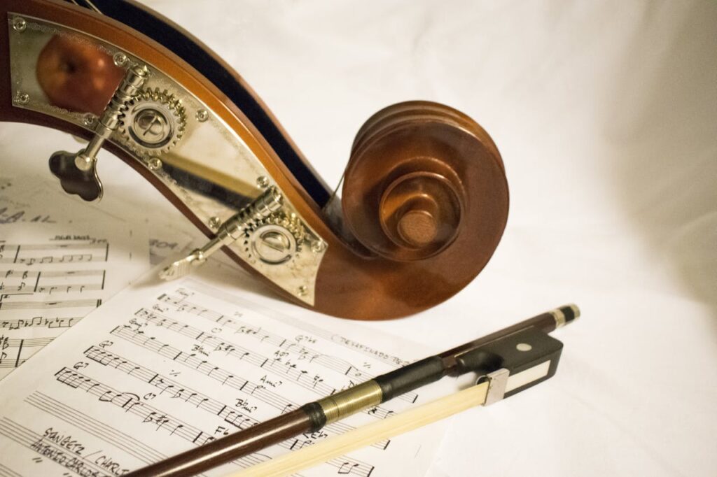 violin resting on sheet music with bow, showing beginner music practice setup